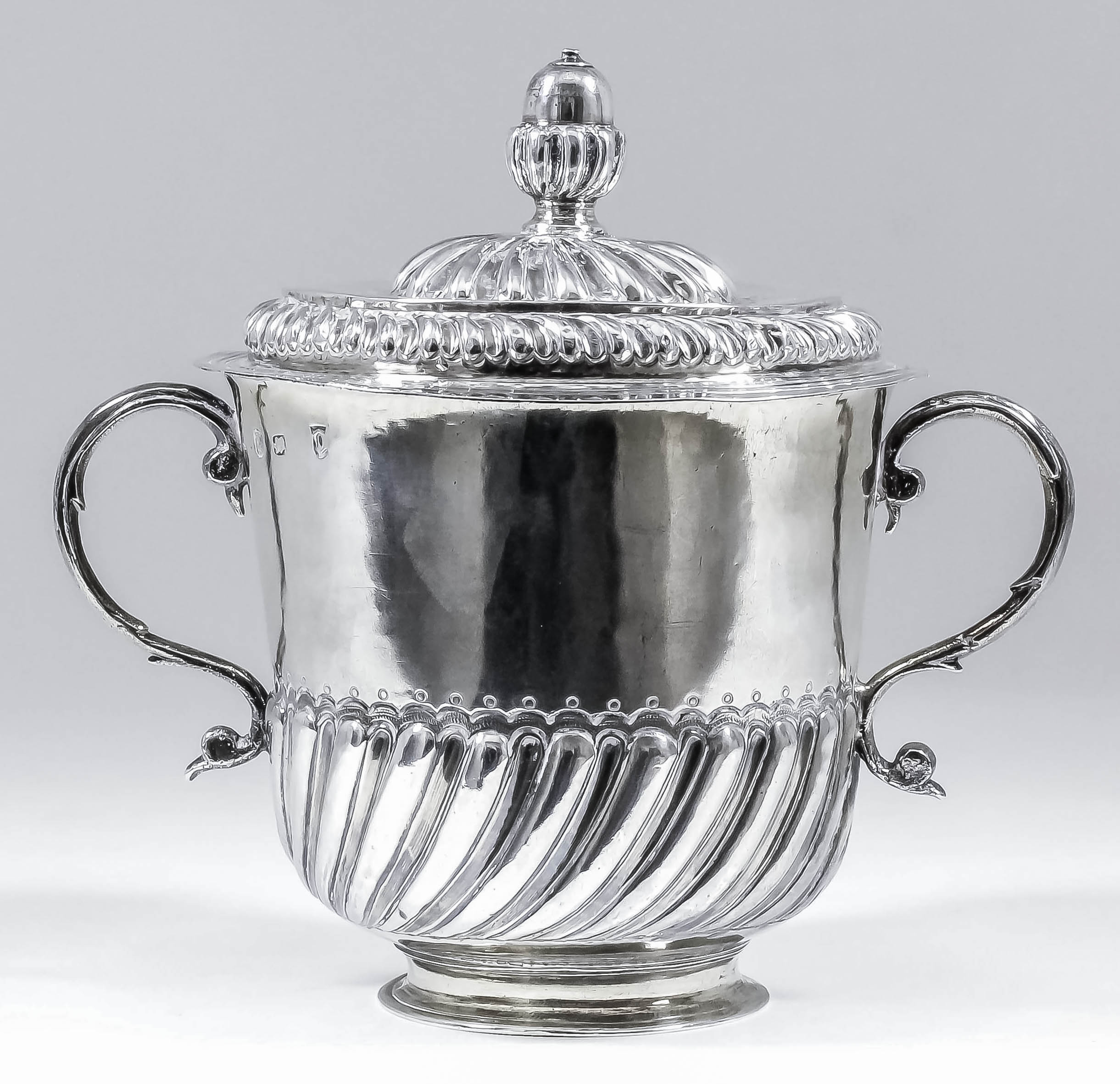 A William and Mary silver gilt two-handled porringer and cover, the body and cover embossed with