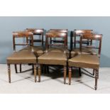 A set of six late George III mahogany dining chairs, the curved crest rails inlaid with stringings