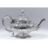 A George IV silver circular teapot of bulbous squat form, with gadroon mounts, the whole embossed