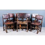 A set of seven late 19th/early 20th Century oak framed dining chairs of "Cromwellian" design,