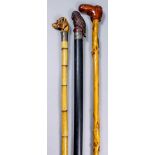 A late 19th Century walking cane, the head modelled in composition with a dogs head, with silver