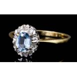 A modern 9ct gold mounted aquamarine and diamond ring, the oval cut aquamarine of approximately .