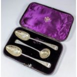 A pair of George III silver and silver gilt table spoons, the bowls engraved with birds perched on