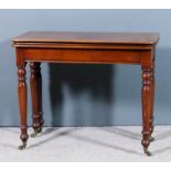 A late Victorian walnut rectangular card table with cleated baize lined folding top, on six baluster