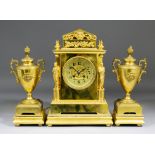 A late 19th/early 20th Century French gilt brass three piece clock garniture, the clock with 3.75ins