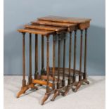 A nest of four Edwardian rosewood and beechwood rectangular occasional tables with rounded