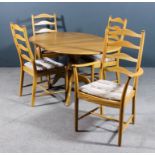 A modern Ercol blonde elm "Penn" design oval extending dining table, with one extra leaf, on