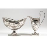 A George III silver oval sugar basket, with reeded mount and bale handle, embossed with ribbons