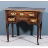 An 18th Century oak lowboy, the three plank top with moulded edge and rounded front corners,