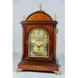 A late 19th Century rosewood cased mantel clock, the 7.5ins arched brass dial with silvered