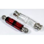 A Victorian silvery metal mounted and ruby glass double ended scent bottle with panel cut body,