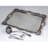 A plated rectangular two-handled tray of shaped and moulded outline, the rim pierced with scroll