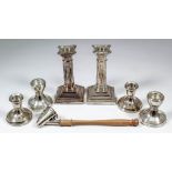 A pair of Edward VII silver pillar candlesticks of Corinthian column pattern, with bead mounts, stop