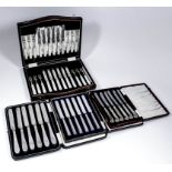 A set of twelve George V silver and mother-of-pearl handled fruit knives and forks by Cooper