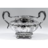 A Victorian silver circular two-handled sugar basin of bulbous squat form, with shell and leaf