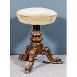 A Victorian walnut circular revolving piano stool, the seat upholstered in mushroom dralon, on