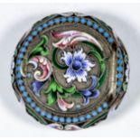 A late 19th Century Russian silvery metal and champleve enamel circular snuff box decorated with