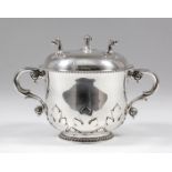 A late Victorian silver circular two-handled porringer with leaf pattern strapwork, double C-