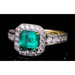 A modern gold coloured metal mounted emerald and diamond ring, the square cut emerald of