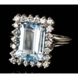 A modern 18ct white gold mounted aquamarine and diamond ring, the oblong cut aquamarine of