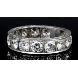 A modern silvery coloured metal mounted all diamond set full hoop eternity ring, the face channel