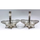 A pair of 19th Century Continental silver oval baskets with swing handles, with moulded edge,