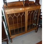 A MAHOGANY DISPLAY CABINET WITH TWO ASTRAGAL GLAZED DOORS, ON CABRIOLE SUPPORTS AND CLAW AND BALL