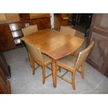 A WALNUTWOOD 1970's DINING ROOM SUITE OF FOUR CHAIRS, A SIDEBOARD AND AN EXTENDING DINING TABLE (6)