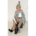 LEONARDO COLLECTION PORCELAIN FIGURE OF A SEATED CLOWN, WITH PLAYING CARDS, IN ORIGINAL BOX WITH