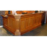 *Panelled walnut reception desk with black flecked marble inset top, 12' long, 6'6" x 45"