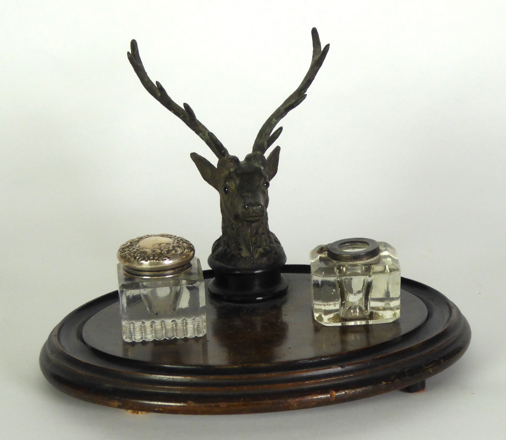 VICTORIAN STAINED FRUIT WOOD AND EBONISED INKSTAND, of oval form with well modelled stags head