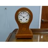 EDWARDIAN INLAID OAK MANTEL CLOCK in balloon shaped case, the 4" Arabic dial powered by an 'Ansonia'