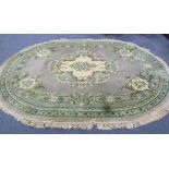 CHINESE OVAL CARPET, with cream and green floral centre medallion on plain pale green field,