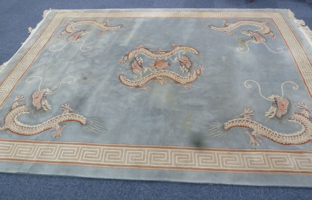 HEAVY QUALITY WASHED CHINESE CARPET, the plain pale blue/grey field embossed in the centre with