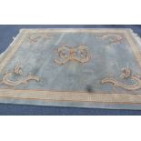 HEAVY QUALITY WASHED CHINESE CARPET, the plain pale blue/grey field embossed in the centre with