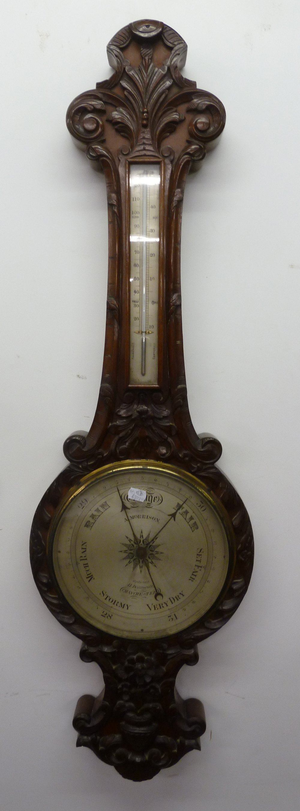 A. MORRISON, OPTICIAN, 41 DEANSGATE, MANCHESTER, BAROMETER, in carved mahogany banjo shaped case,