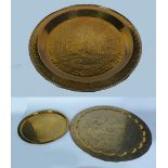 LARGE MIDDLE EASTERN ENGRAVED BRASS WALL PLAQUE, circular form with raised border, intricately