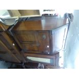 A SMALL OAK BUREAU WITH DRAWER AND CUPBOARD BELOW