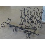 BLACK WROUGHT IRON TABLE TOP BOTTLE RACK AND A SIMILAR HANGING BOTTLE RACK WITH MATCHING BRACKET.