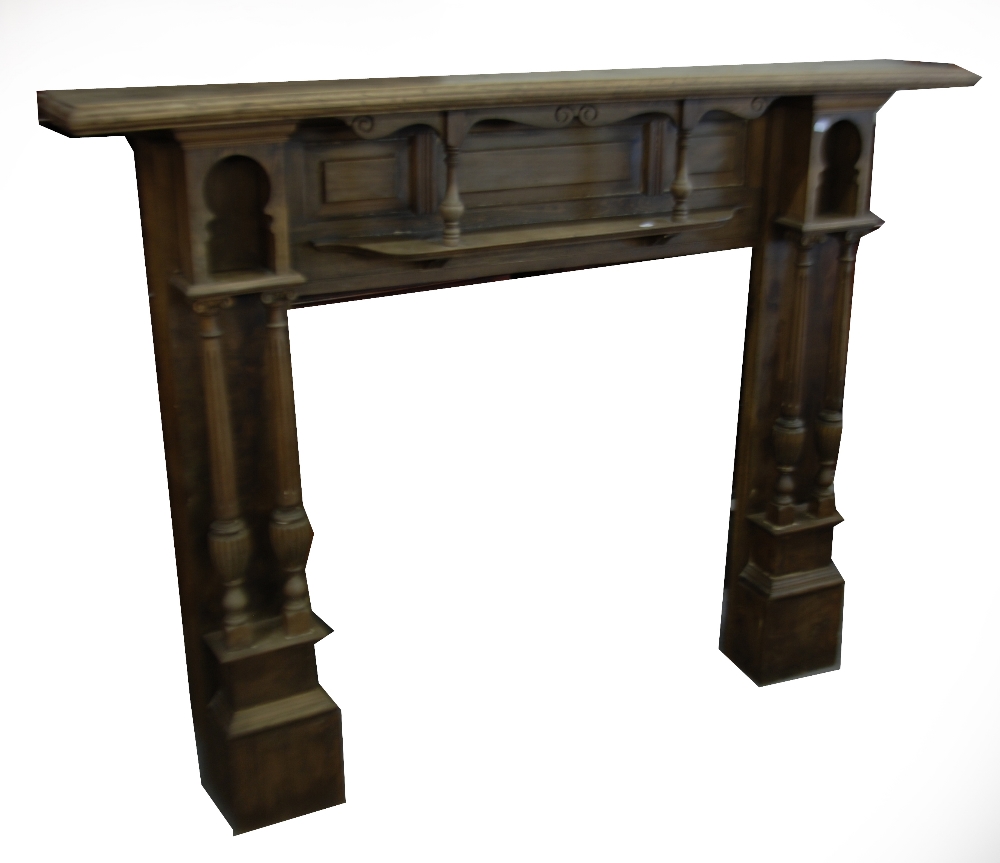 A CARVED AND STAINED WOOD FIRE SURROUND WITH TWIN SIDE COLUMNS, 5'9" WIDE