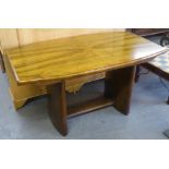 ART DECO FIGURED WALNUT DINNING TABLE, THE SHAPED RECTANGULAR TOP WITH CARVED DETAIL TO THE ENDS AND