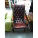 A MAHOGANY REGENCY STYLE EASY ARMCHAIR, BUTTON UPHOLSTERED IN CRIMSON HIDE
