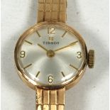 LADY'S 'TISSOT' 9ct GOLD WRIST WATCH, with mechanical movement, circular silvered dial with integral