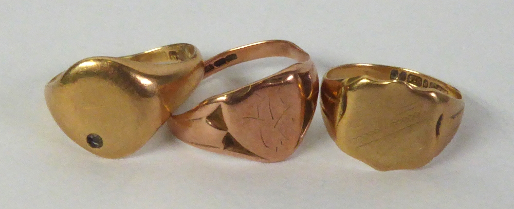 TWO 9ct GOLD SIGNET RINGS, with shield shaped tops and ANOTHER WITH OVAL TOP, 11gms in total