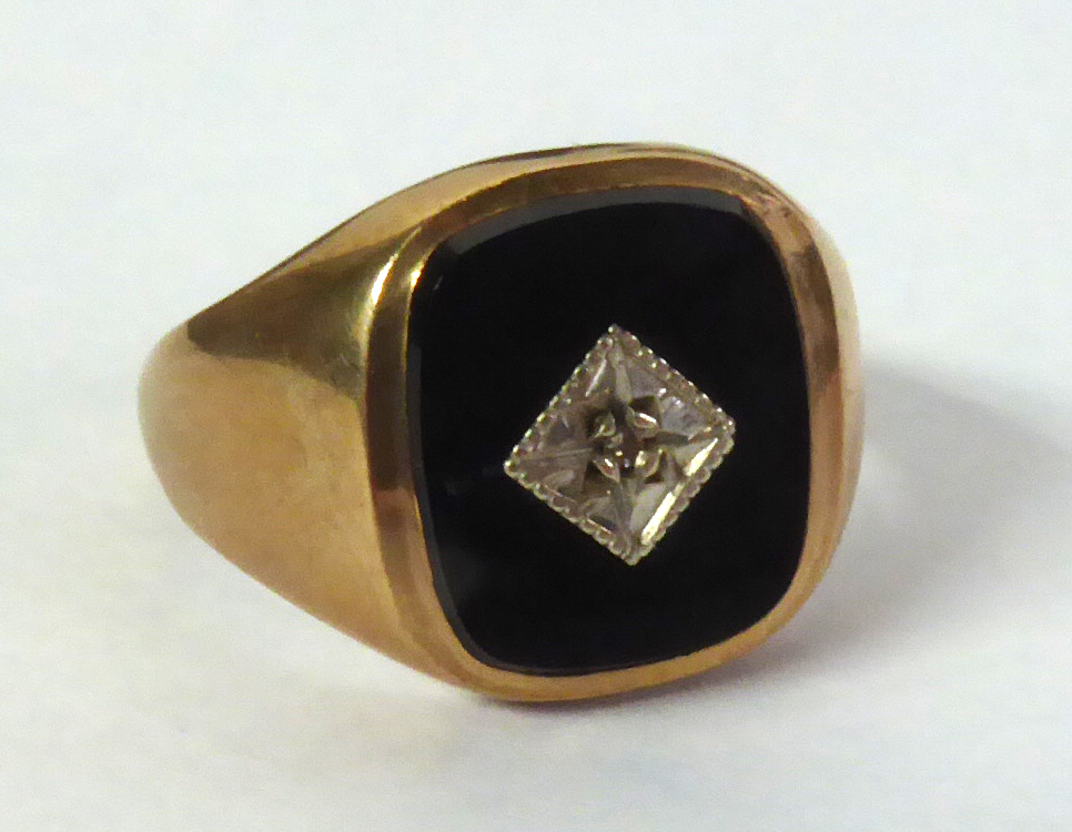 9ct GOLD SIGNET RING, the oblong black onyx top having a tiny diamond in a deceptive setting, London
