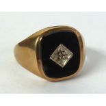 9ct GOLD SIGNET RING, the oblong black onyx top having a tiny diamond in a deceptive setting, London