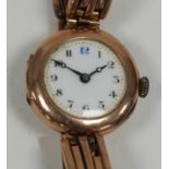 LADY'S 9ct GOLD CASED WRIST WATCH, with circular white porcelain Arabic dial, circular case with 9ct