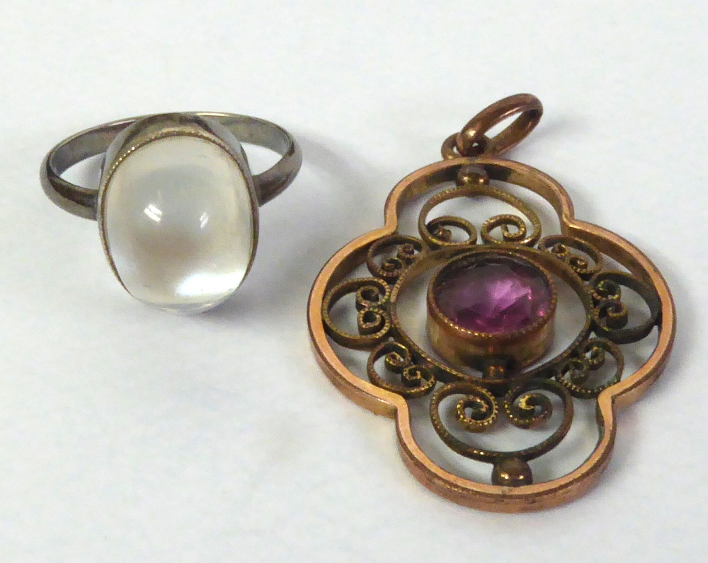 A ROLLED GOLD QUATRE FOIL OPENWORK PENDANT, set with a centre amethyst and a SILVER COLOURED METAL