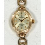 LADY'S SOVEREIGN 9 CT GOLD WRIST WATCH, the silvered oval dial with batons, and the 9 ct gold