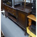 AN EARLY TWENTIETH CENTURY MAHOGANY BREAKFRONT SIDEBOARD WITH LEDGE BACK ON CABRIOLE LEGS